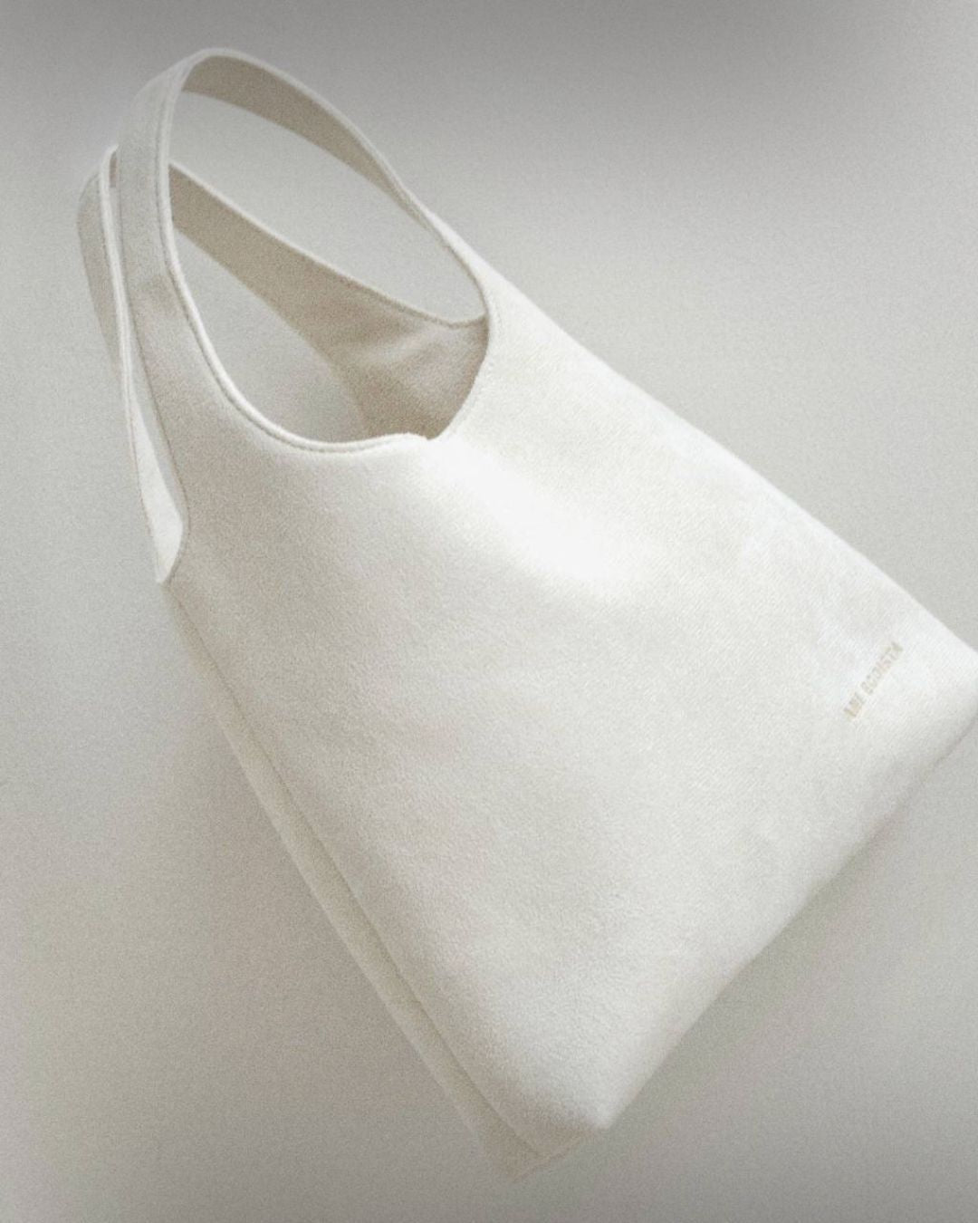 White reusable bag by Enso Design Lab, designed by Ani Han. The bag emphasizes sustainability and minimalist design, perfect for everyday use.