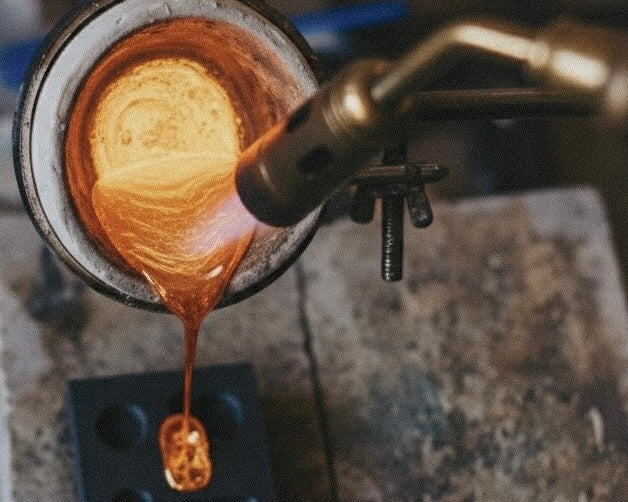 Close-up of the gold brewing process with the flow of poured gold.