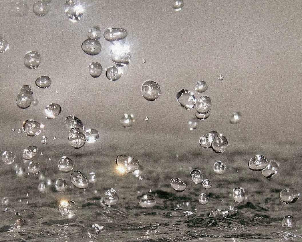 Bubbles floating in a liquid with a gray background