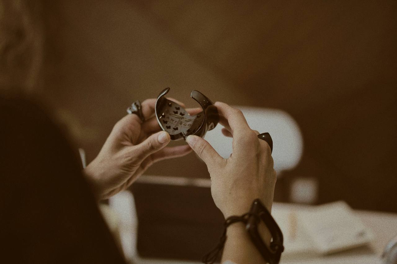 Hands working on a detailed piece, illustrating the intricate craftsmanship and attention to detail at Enso Design Lab.