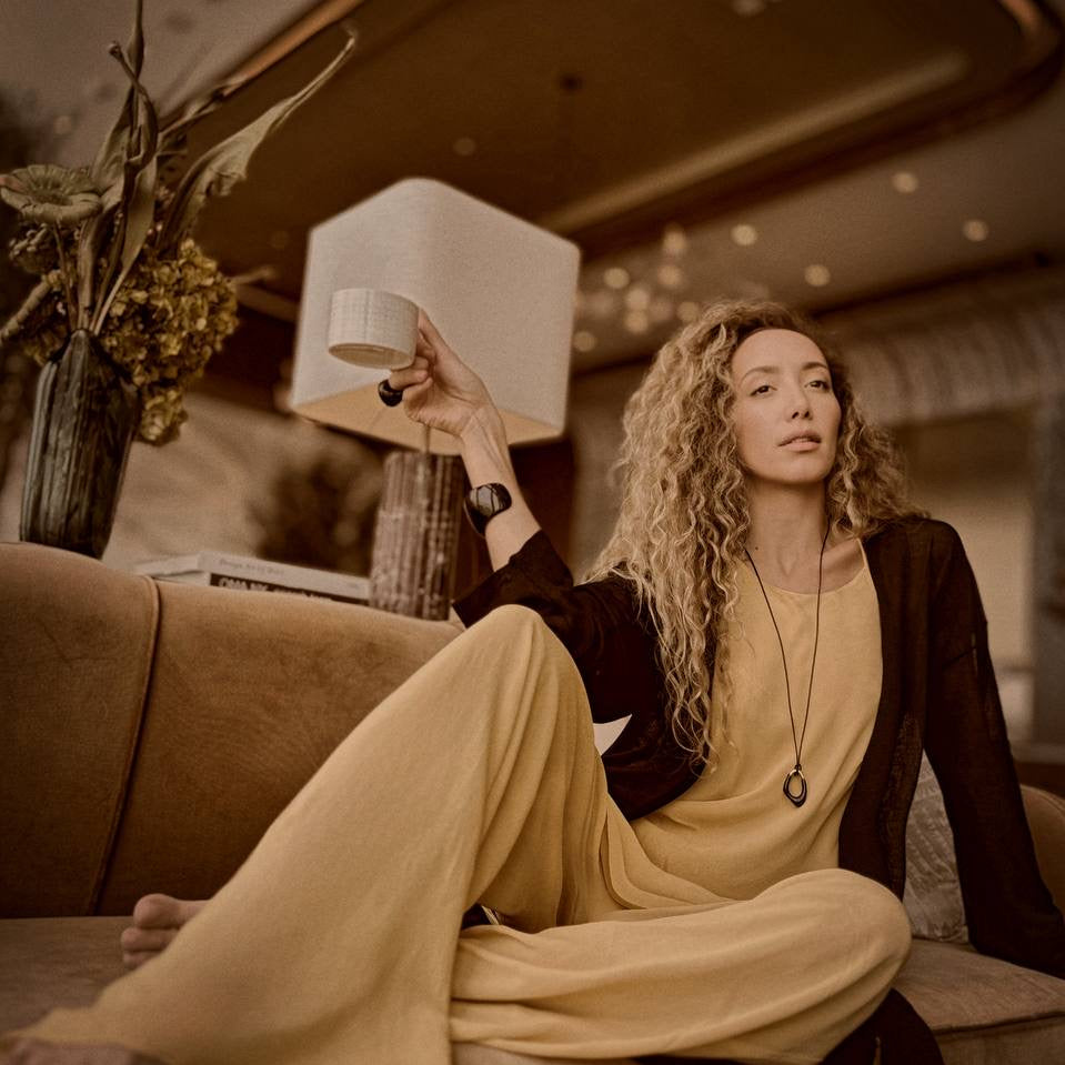 Ani Han, Creative Director of Enso, stands elegantly beside a marble table, embodying the refined minimalism and quiet luxury that define her design philosophy.