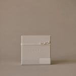 Close-up of Enso Design Lab™ packaging with embossed logo and smooth textured surface.