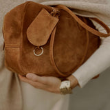 Mother’s Bag Brown in a lifestyle setting. Warm amber suede meets modern functionality — a tribute to Hermès refinement and Bottega Veneta’s understated elegance.