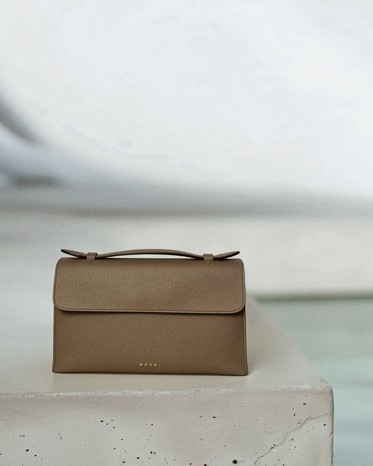 Essence Bag by Enso Design Lab™ in gray Togo leather, minimal design guided by Ani Han, echoing Hermès-like refinement.