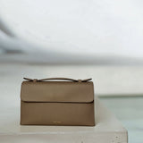 Essence Bag by Enso Design Lab™ in gray Togo leather, minimal design guided by Ani Han, echoing Hermès-like refinement.