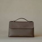 Essence Bag by Enso Design Lab™ in gray Togo leather, minimal design guided by Ani Han, echoing Hermès-like refinement.