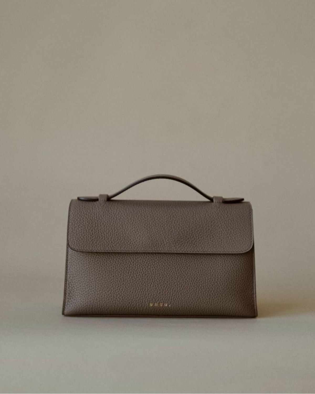 Essence Bag by Enso Design Lab™ in gray Togo leather, minimal design guided by Ani Han, echoing Hermès-like refinement.