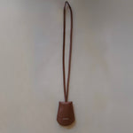 Front view of the Leather Key Holder Necklace in Golden Brown Pebbled Leather by Enso Design Lab™, designed by Ani Han.