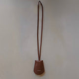 Front view of the Leather Key Holder Necklace in Golden Brown Pebbled Leather by Enso Design Lab™, designed by Ani Han.