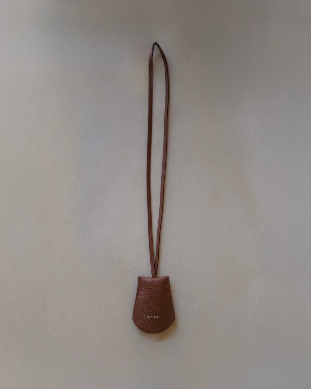 Front view of the Leather Key Holder Necklace in Golden Brown Pebbled Leather by Enso Design Lab™, designed by Ani Han.