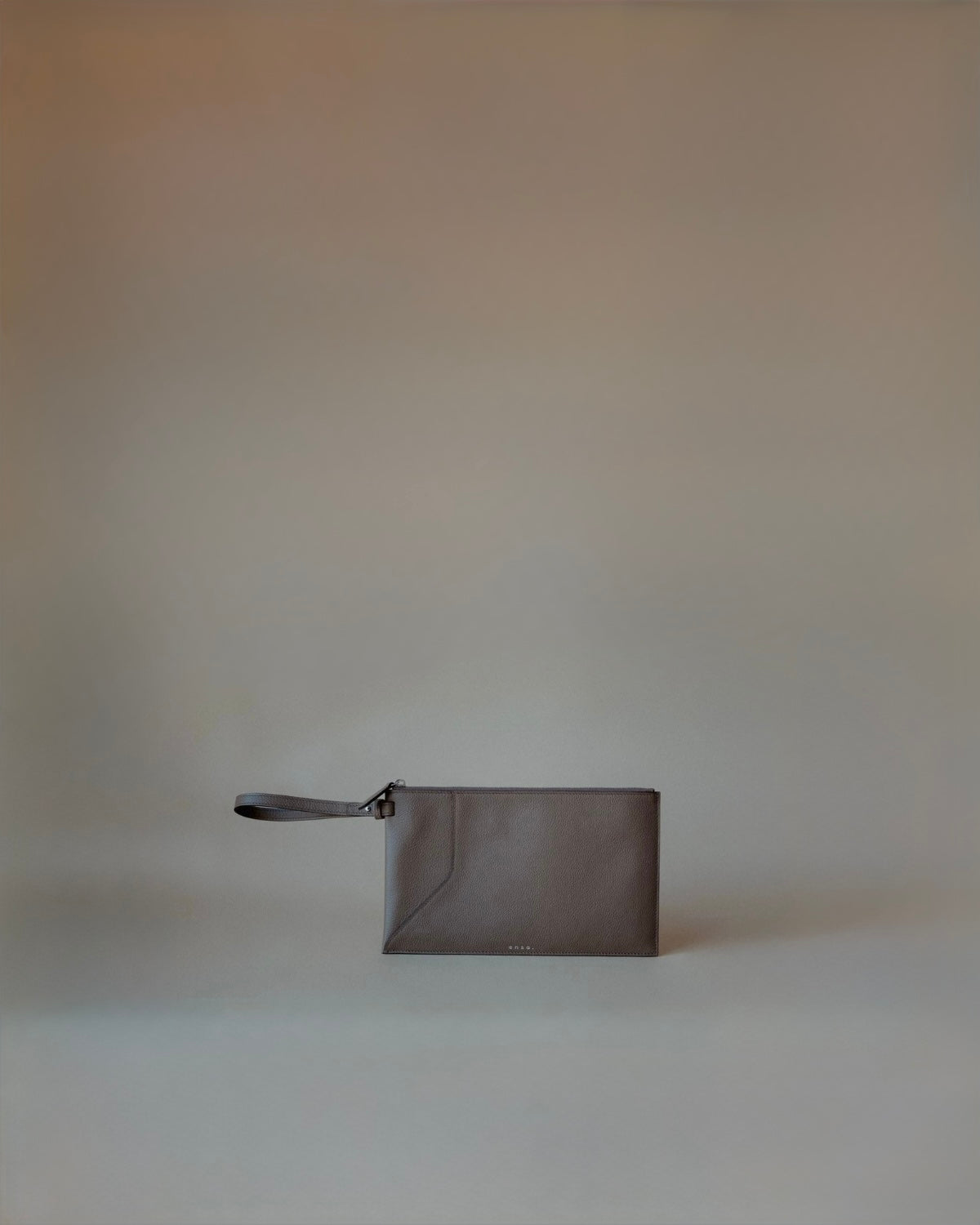 Front view of the Wristlet Leather Pouch in Grey Pebbled Leather by Enso Design Lab™, designed by Ani Han.