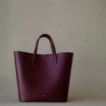 Element Tote Bag by Enso Design Lab™ in burgundy cowhide leather, minimal design guided by Ani Han, quietly echoing Hermès-like refinement.