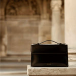 Essence Bag by Enso Design Lab™ in black box leather, its minimal design guided by Ani Han, evoking the quiet refinement of Hermès-like silhouettes.