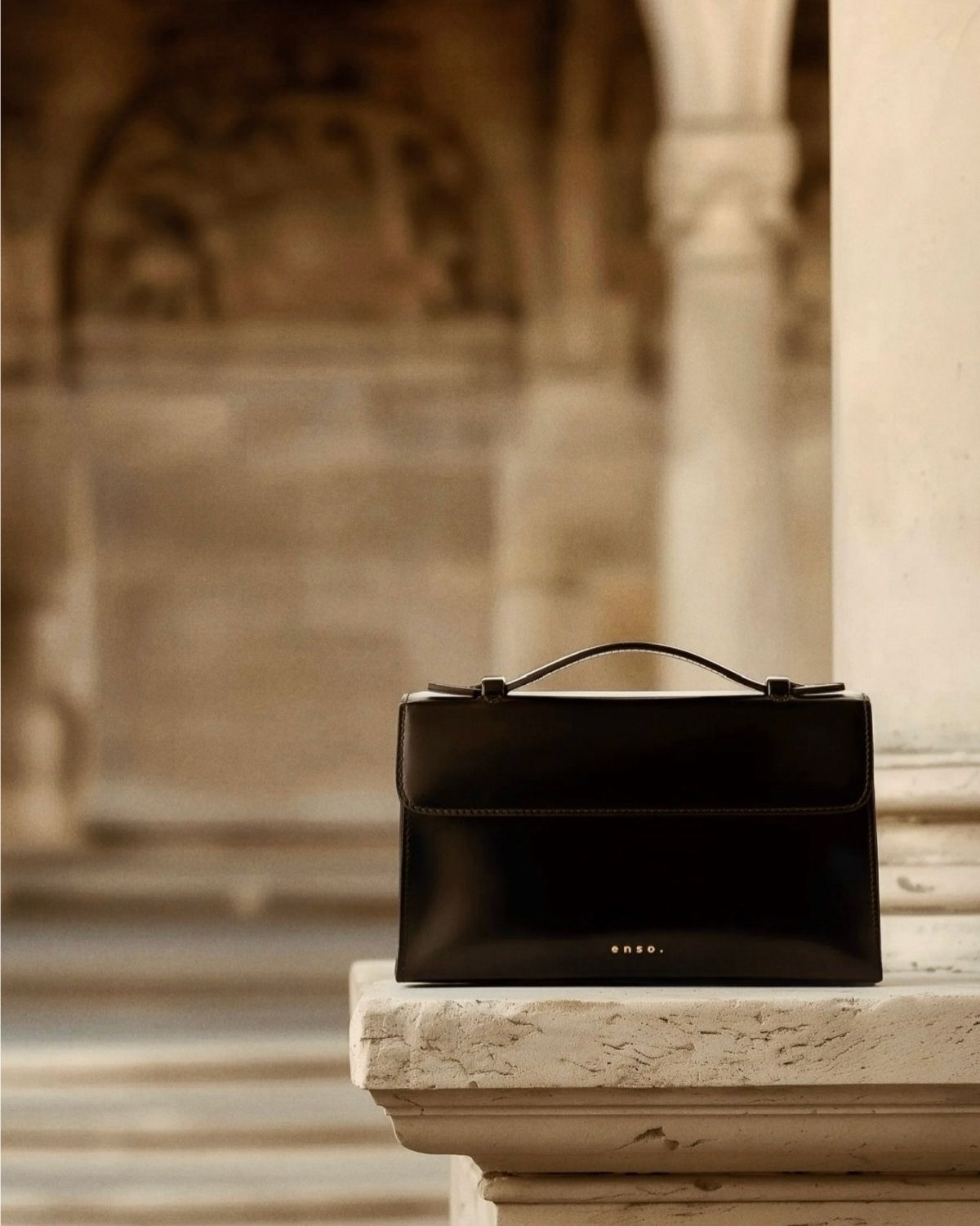 Essence Bag by Enso Design Lab™ in black box leather, its minimal design guided by Ani Han, evoking the quiet refinement of Hermès-like silhouettes.