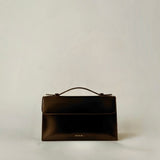 Essence Bag by Enso Design Lab™ in black box leather, its minimal design guided by Ani Han, evoking the quiet refinement of Hermès-like silhouettes.