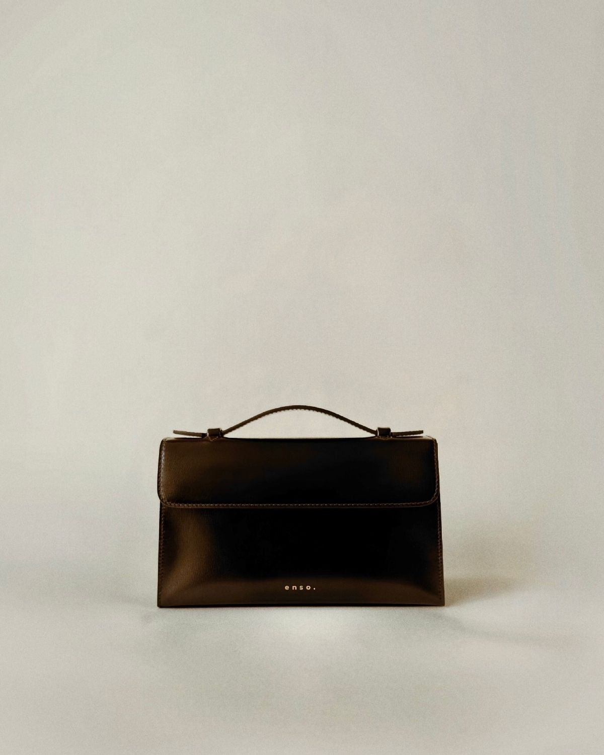 Essence Bag by Enso Design Lab™ in black box leather, its minimal design guided by Ani Han, evoking the quiet refinement of Hermès-like silhouettes.