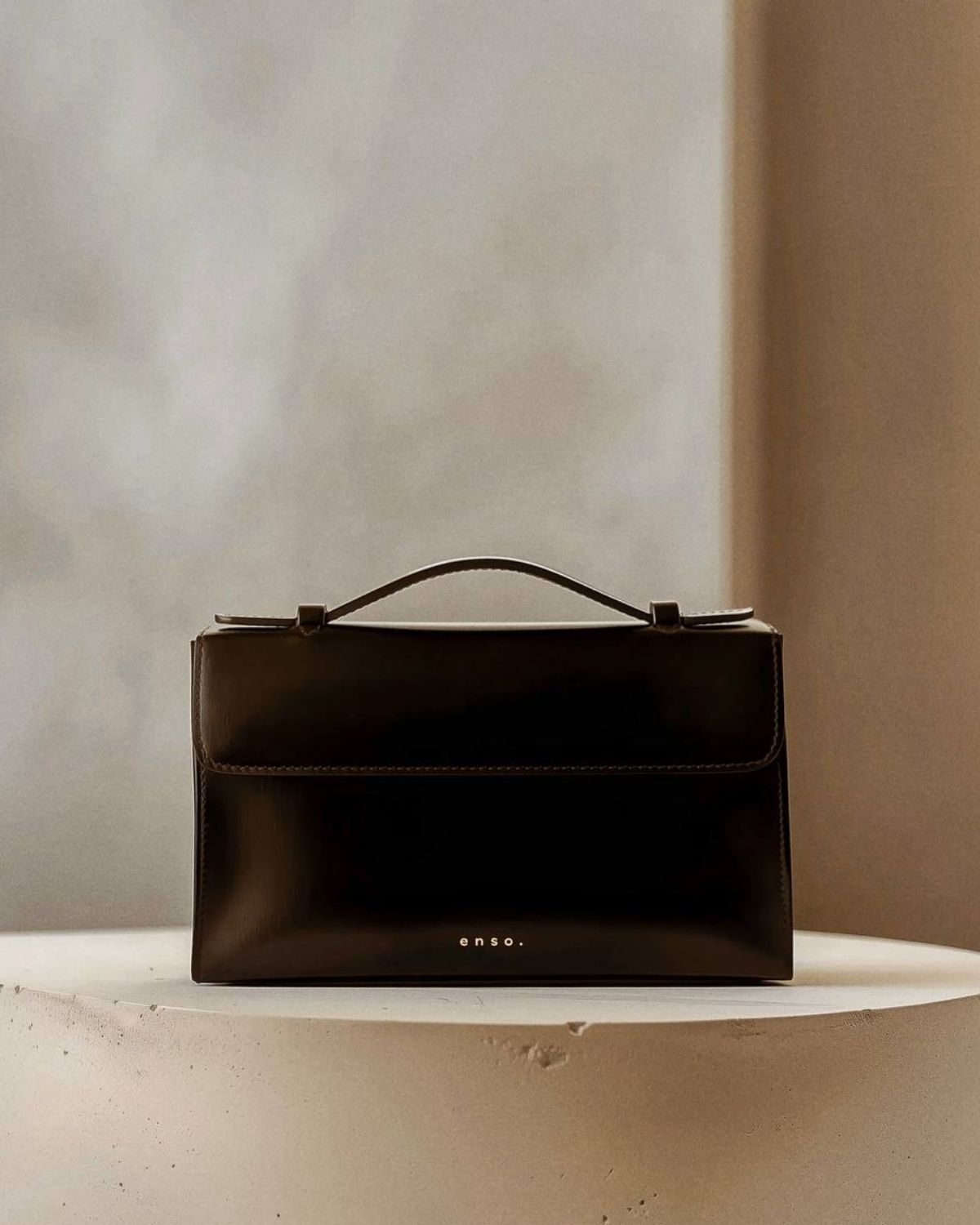 Essence Bag by Enso Design Lab™ in black box leather, its minimal design guided by Ani Han, evoking the quiet refinement of Hermès-like silhouettes.