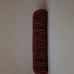 Folded burgundy cashmere scarf by Enso Design Lab™, blending timeless elegance with modern design.