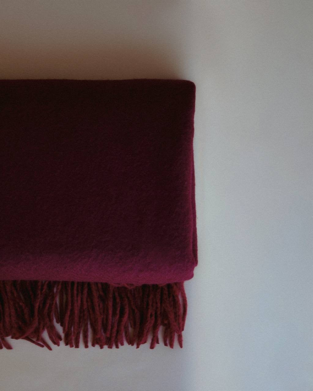 Luxurious cashmere scarf by Enso Design Lab™, crafted under the vision of Creative Director Ani Han, in a deep burgundy shade with soft fringes.