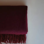 Luxurious cashmere scarf by Enso Design Lab™, crafted under the vision of Creative Director Ani Han, in a deep burgundy shade with soft fringes.