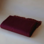 Folded burgundy cashmere scarf by Enso Design Lab™, blending timeless elegance with modern design.