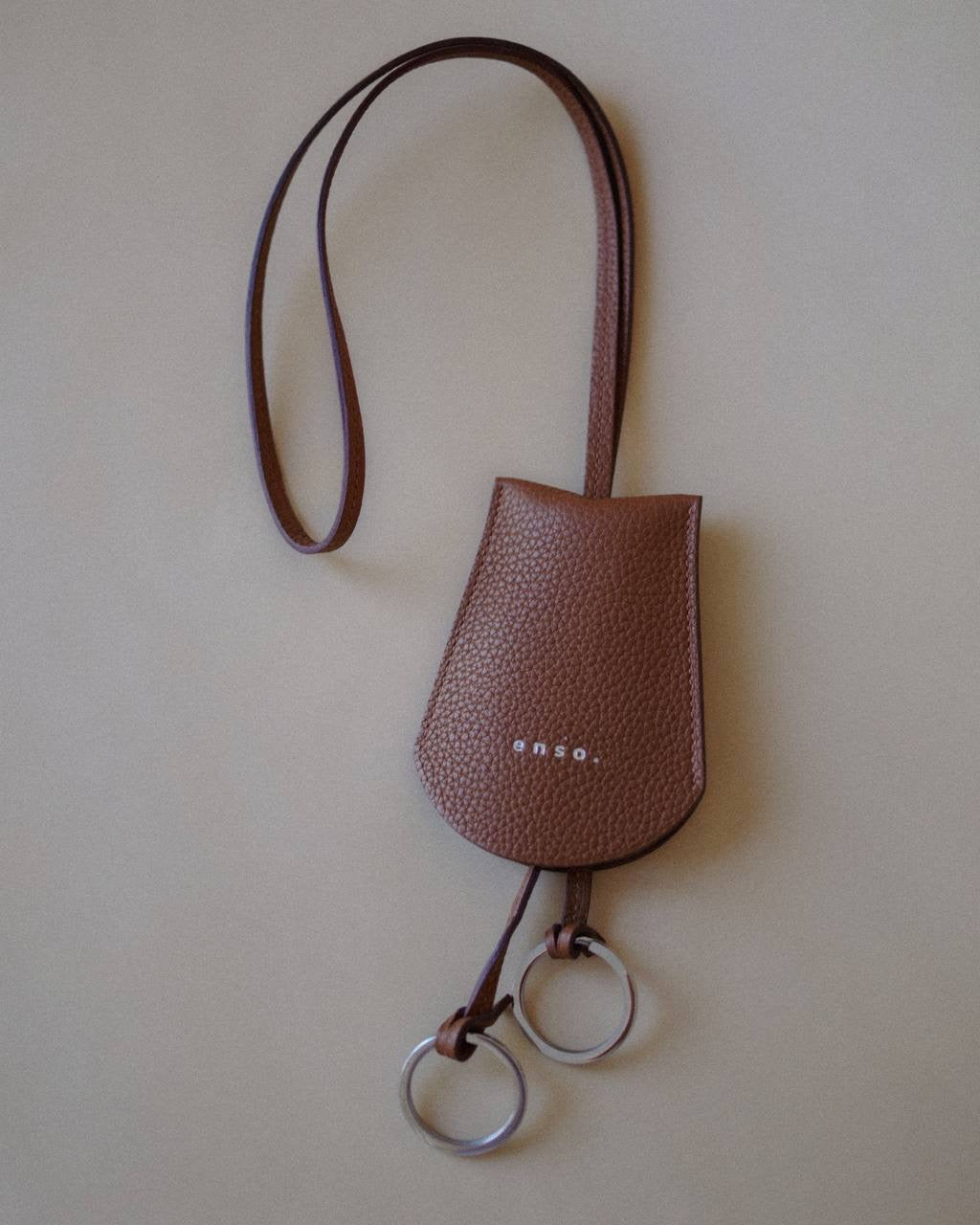 Top view of the Leather Key Holder Necklace, emphasizing the textured pebbled leather and secure design.