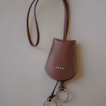 Top view of the Leather Key Holder Necklace, emphasizing the textured pebbled leather and secure design.