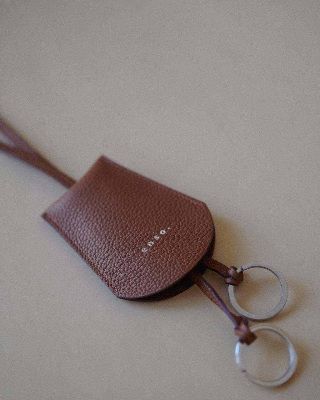 Top view of the Leather Key Holder Necklace, emphasizing the textured pebbled leather and secure design.