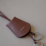 Top view of the Leather Key Holder Necklace, emphasizing the textured pebbled leather and secure design.