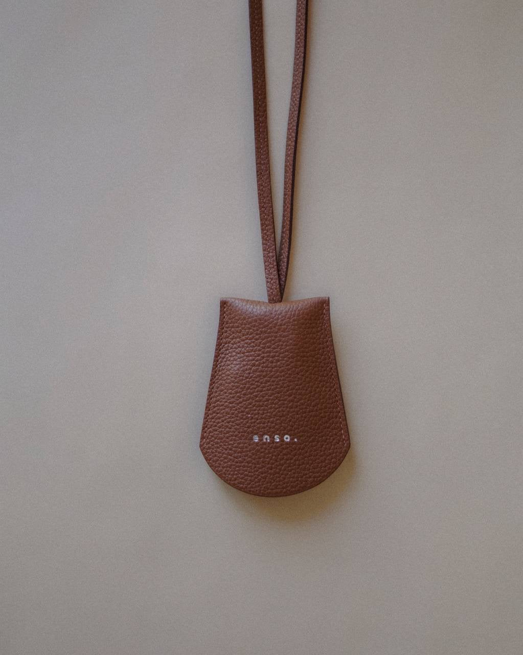 Close-up of the Leather Key Holder Necklace, highlighting the durable metal key rings and premium leather strap.