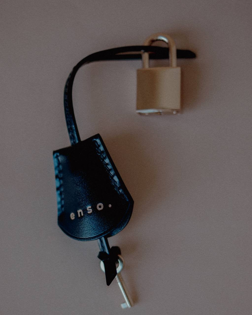 Top view of the Leather Key Charm with Decorative Padlock, showcasing its versatility as a bag charm or key accessory.