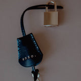 Top view of the Leather Key Charm with Decorative Padlock, showcasing its versatility as a bag charm or key accessory.