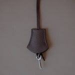 Top view of the Grey Leather Key Charm by Enso Design Lab™, emphasizing its seamless stitching and refined materials.