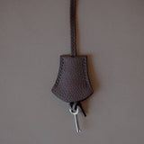 Top view of the Grey Leather Key Charm by Enso Design Lab™, emphasizing its seamless stitching and refined materials.