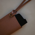 Side view of the Golden Brown Leather Sunglasses Holder, showcasing its pebbled leather texture and minimalist design.