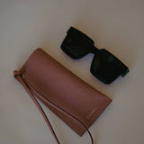 Elegant Leather Sunglasses Holder with Strap, designed for everyday use with a touch of sophistication by Ani Han.