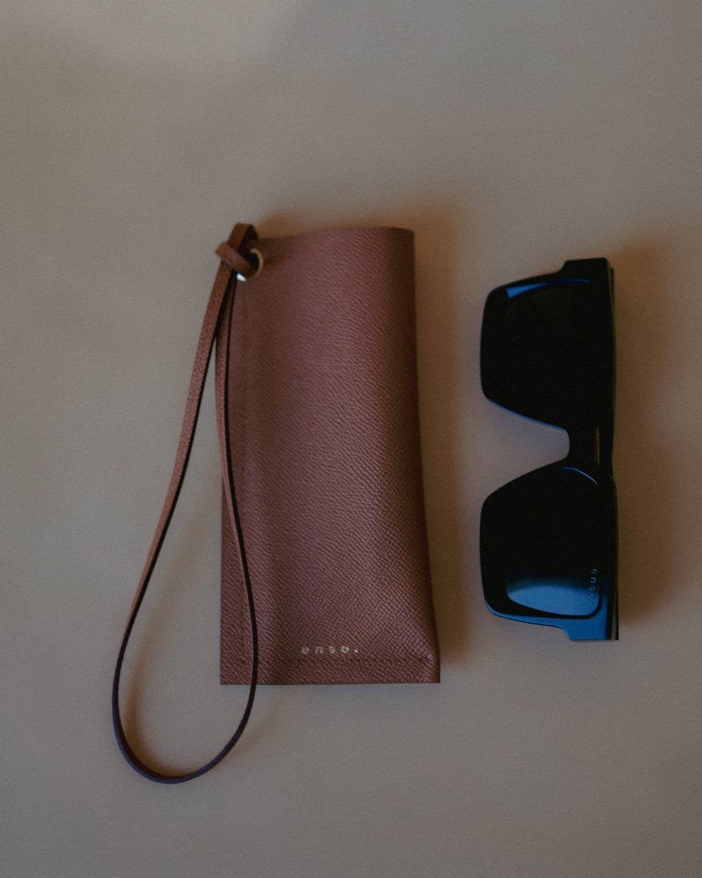 Elegant Leather Sunglasses Holder with Strap, designed for everyday use with a touch of sophistication by Ani Han.