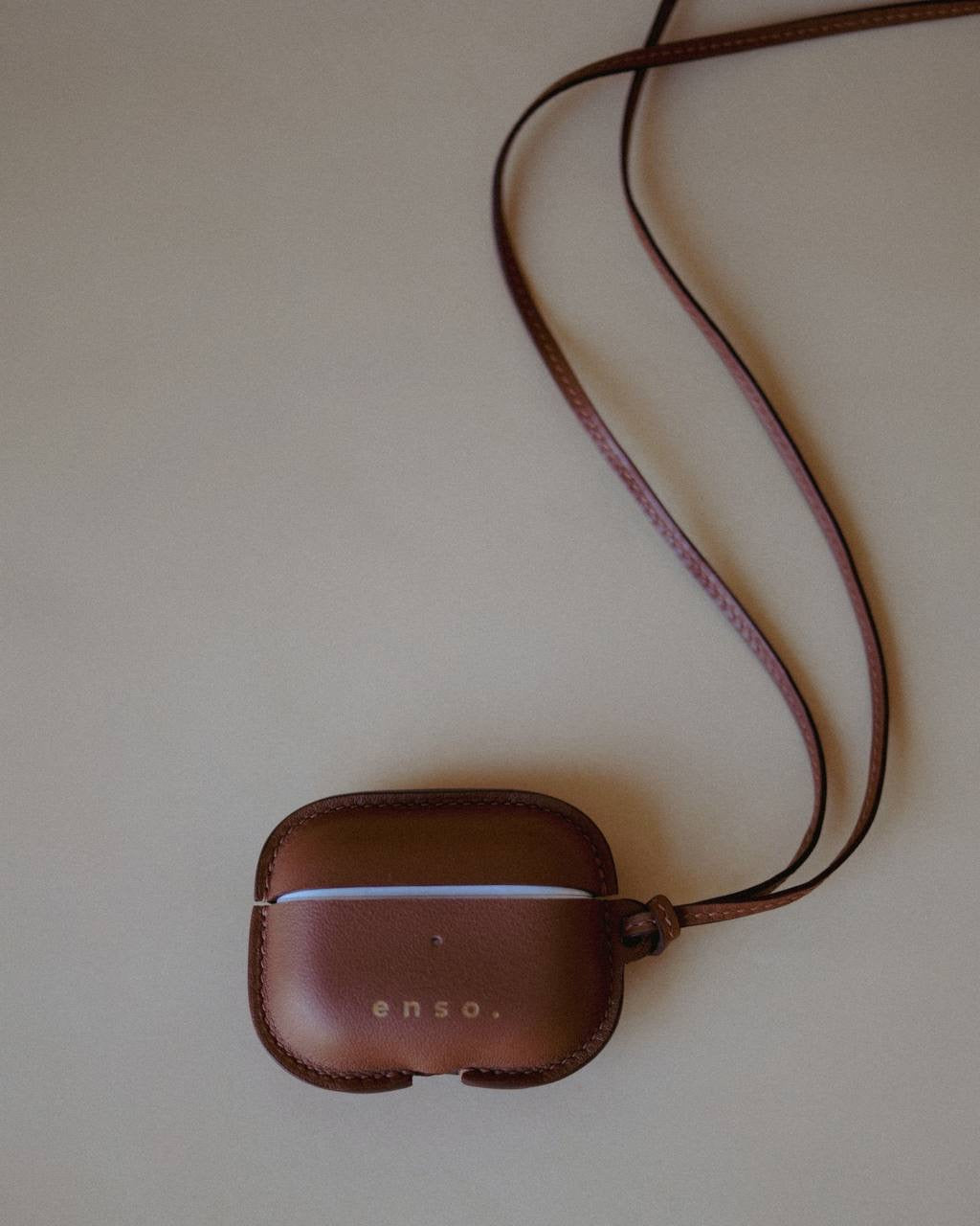 Front view of the Leather AirPods Case Necklace in Golden Brown Swift Leather by Enso Design Lab™, designed under the creative vision of Ani Han.