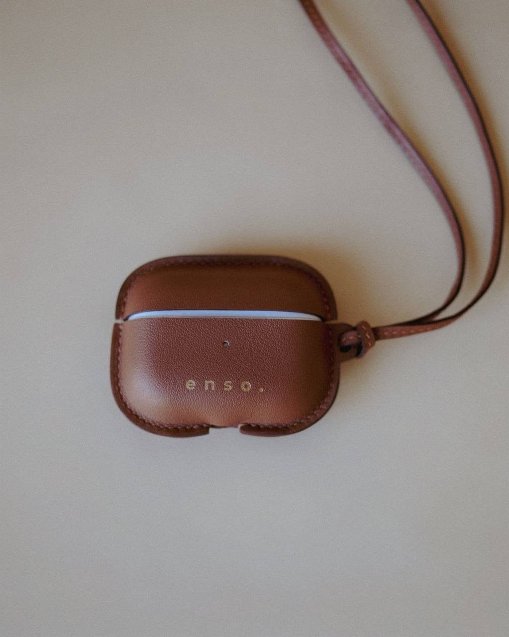 Side view of the Leather AirPods Case Necklace in Golden Brown, emphasizing the timeless design crafted under the creative direction of Ani Han.