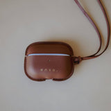 Side view of the Leather AirPods Case Necklace in Golden Brown, emphasizing the timeless design crafted under the creative direction of Ani Han.