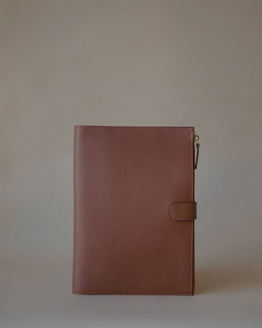 Side view of the Organizer Case, showcasing its textured Golden Brown leather and minimalist design.