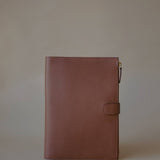 Side view of the Organizer Case, showcasing its textured Golden Brown leather and minimalist design.