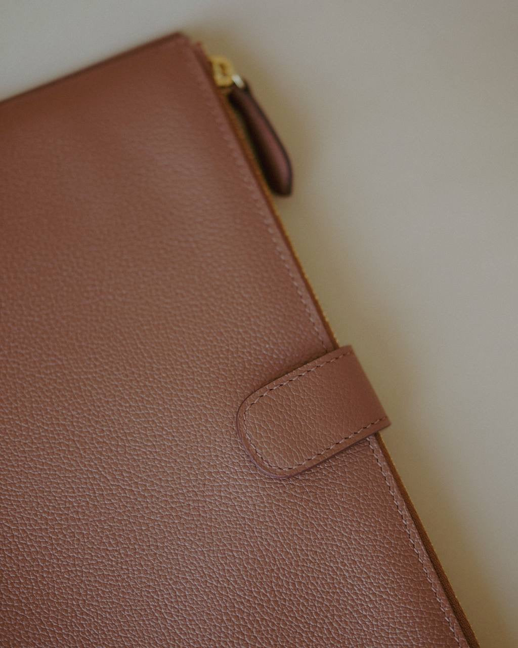 Close-up of the Leather Organizer Case, highlighting the pebbled leather texture and durable zip closure.