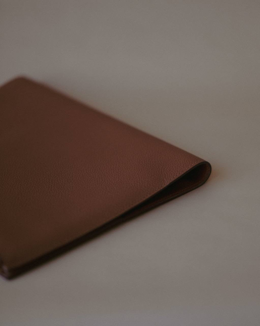 Side view of the Organizer Case, showcasing its textured Golden Brown leather and minimalist design.