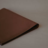 Side view of the Organizer Case, showcasing its textured Golden Brown leather and minimalist design.