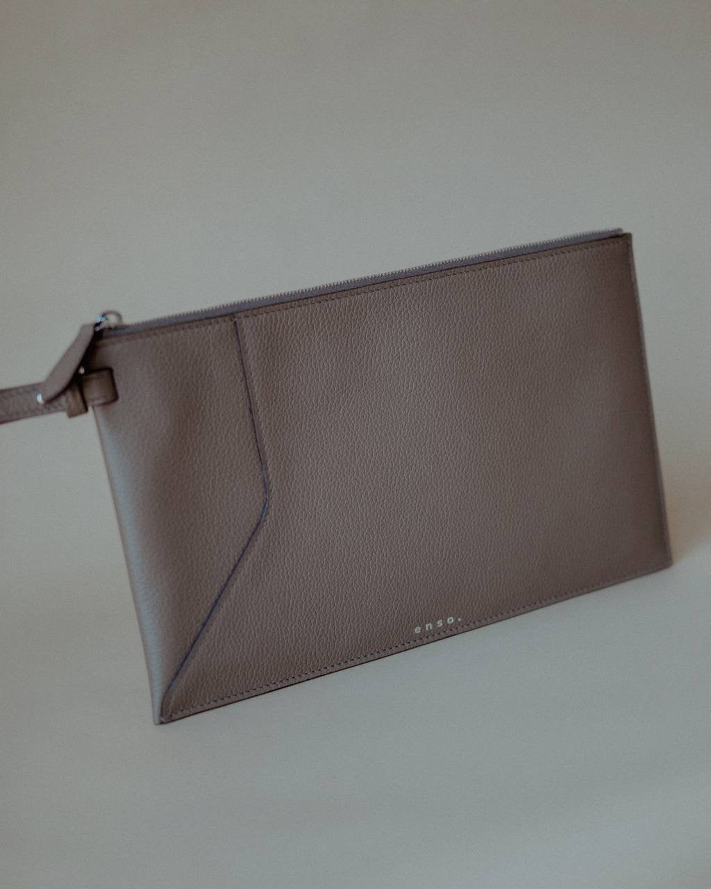 Open view of the Wristlet Leather Pouch, revealing its spacious interior and secure zip closure.