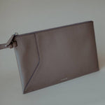 Open view of the Wristlet Leather Pouch, revealing its spacious interior and secure zip closure.