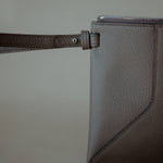 Close-up of the detachable wrist strap, highlighting the pouch’s elegant and functional design.