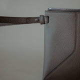 Close-up of the detachable wrist strap, highlighting the pouch’s elegant and functional design.