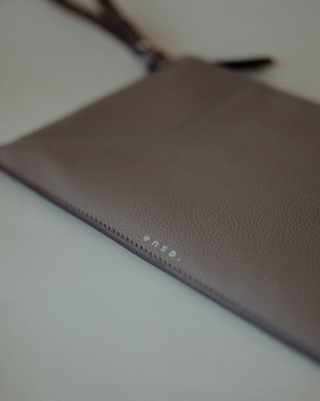 Front view of the Wristlet Leather Pouch in Grey Pebbled Leather by Enso Design Lab™, designed by Ani Han.